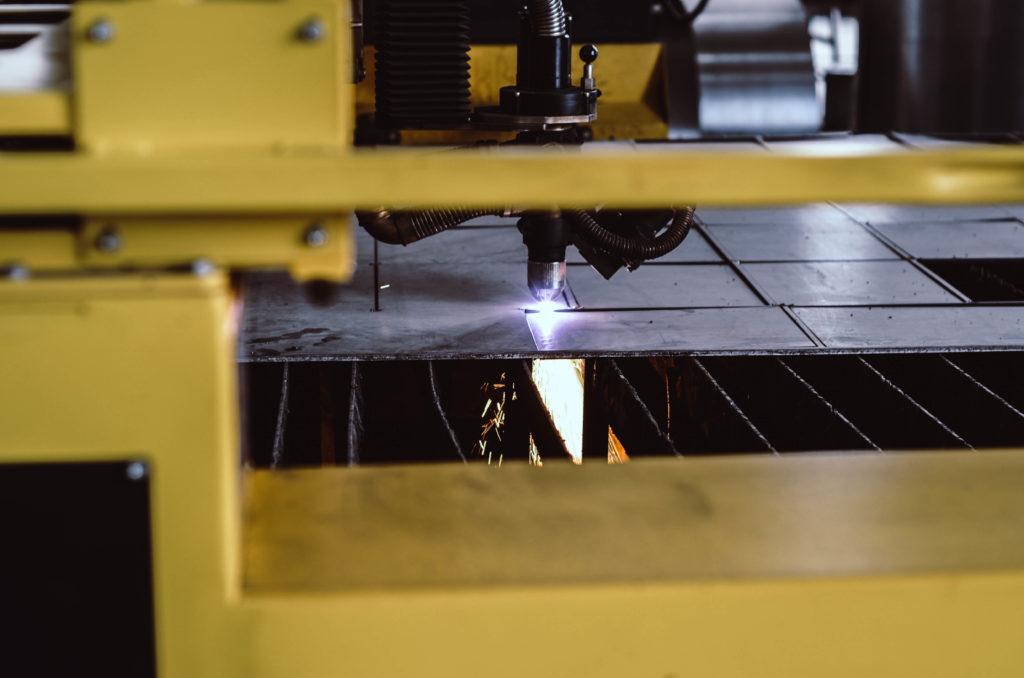 Close up of a steel fabrication machine with laser.